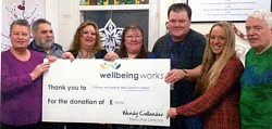 Cheque from league to Wellbeing Dundee presented by David Robbins
